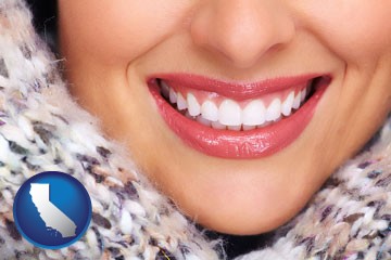 beautiful white teeth forming a beautiful smile - with California icon