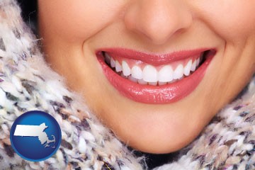 beautiful white teeth forming a beautiful smile - with Massachusetts icon
