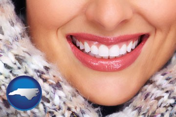beautiful white teeth forming a beautiful smile - with North Carolina icon