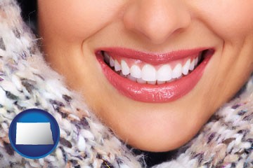 beautiful white teeth forming a beautiful smile - with North Dakota icon