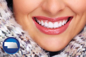 beautiful white teeth forming a beautiful smile - with Nebraska icon