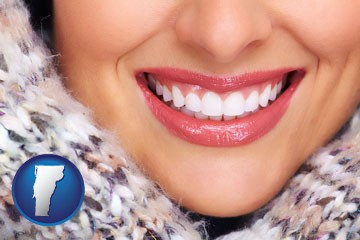 beautiful white teeth forming a beautiful smile - with Vermont icon